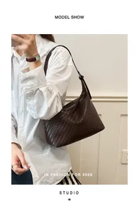 Detailed view of the dark brown woven texture on a minimalist hobo bag for women
