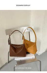 Close-up showing woven texture of brown and yellow hobo shoulder bags on a chair