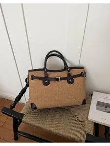 Detail view of a retro woven tote bag with brown trim showing its texture and design.