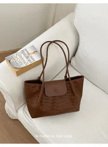 Large brown woven tote bag for women featuring a sleek flap and commuter style.