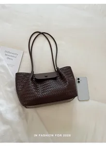 Detailed view of the dark brown woven pattern on a stylish women's commuter tote bag