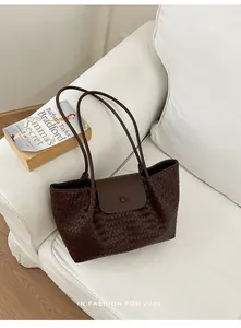 Detailed view of the dark brown woven texture on this stylish underarm tote bag