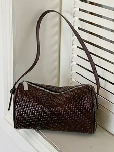 Vintage dark brown woven cylindrical barrel underarm shoulder bag for women with long strap.