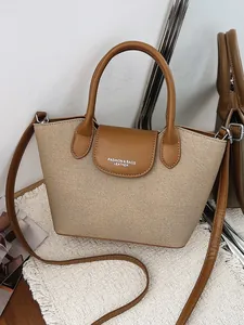 Vintage style women's crossbody handbag featuring beige canvas and brown leather trim