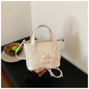 Crèmekleurige gewatteerde bucket bag met konijn bedel en parelmoer hartje