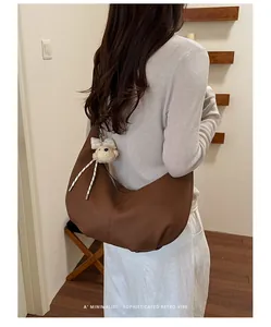Brown pleated faux leather hobo bag styled as an underarm shoulder bag for women