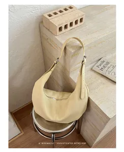 Sophisticated retro cream yellow pleated underarm bag with elegant pebble grain leather.