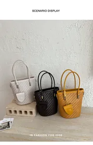 Detailed view of fashionable woven bucket bags in white, black and yellow for summer 2026