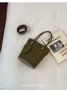 Stylish olive green woven bucket bag with shoulder strap for elegant commuter women