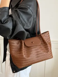 Stylish large capacity brown woven leather tote bag for women shoulder or underarm carry.