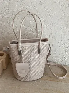 Elegant beige woven bucket bag for women with a top handle and adjustable crossbody strap
