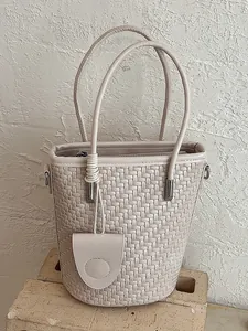 Beige woven bucket bag for women with dual top handles and minimalist design