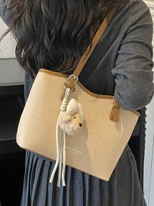 Sophisticated beige large capacity tote bag with cute plush dog charm for commuting