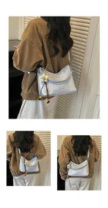 Light blue polka dot bucket shoulder bag worn by a model in a casual lifestyle setting