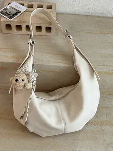 Minimalist retro cream ruched hobo bag with cute plush bear charm for commuting women.