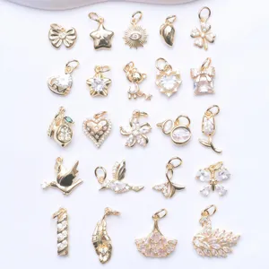 Assorted 14K gold-filled charms featuring swan, heart, and zircon inlay designs