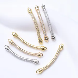Detailed view of 18K gold-plated curved tube connectors with sparkling zirconia.