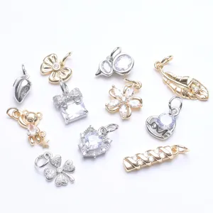 Collection of various 14K gold-filled and silver charms with zircons for jewelry
