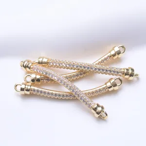 Detail of 18K gold-clad curved tube connectors with sparkling zircon inlays for DIY jewelry.