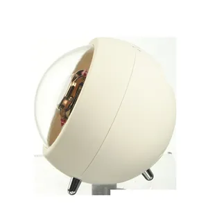 Detailed view of a sleek cream spherical automatic watch winder for mechanical watches