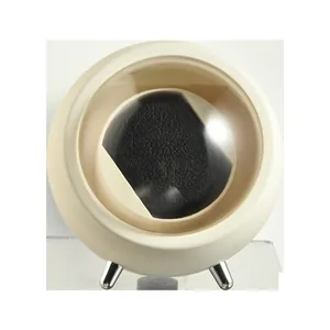 Macro view of a modern cream spherical automatic watch winder with a clear window