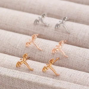 Minimalist flying dragon stud earrings available in gold, silver, and rose gold
