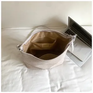 Detailed interior view of a beige woven tote bag showing inner pockets and lining