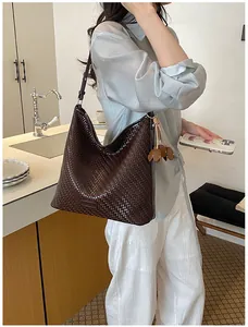 Elegant dark brown large woven tote bag for women shown in a lifestyle kitchen setting