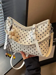 Chic white polka dot bucket bag with flower charm and adjustable shoulder strap