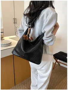Minimalist large capacity woven tote bag for women commuting in a modern kitchen setting.