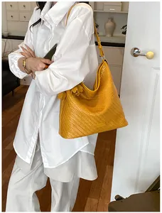 Large yellow woven tote bag for women showing detailed texture and commuter style.