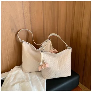 Elegant cream woven tote bag set with decorative flower charms in a lifestyle scene