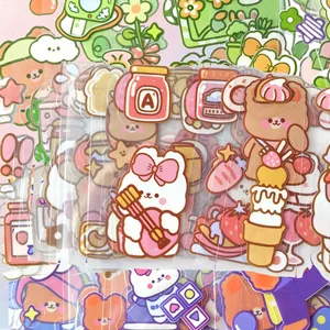 Close-up of cute cartoon PET stickers featuring bears and rabbits for DIY journaling
