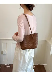 Premium brown woven leather tote bag for women showing intricate braided details on model