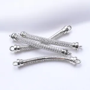 Detailed view of silver-plated curved tube connectors with paved cubic zirconia