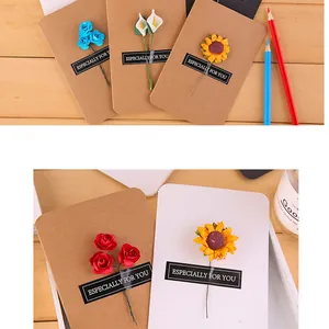 Detailed view of handmade vintage kraft greeting cards with small artificial flowers