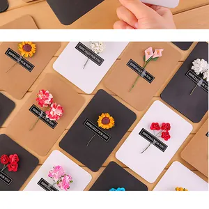 Close-up of vintage kraft greeting cards with colorful artificial flower decorations