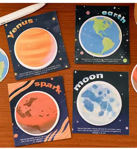 Gros plan détaillé de quatre blocs-notes adhésifs esthétiques sur le thème des planètes