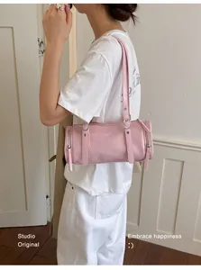 Close-up of a minimalist light pink pillow shoulder bag perfect for summer commuting