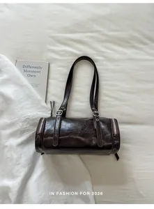 Detail view of the vintage brown faux leather pillow bag with silver hardware