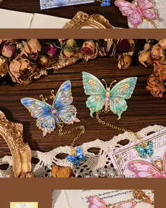 Detailed view of vintage enamel butterfly metal bookmarks with delicate chains and charms