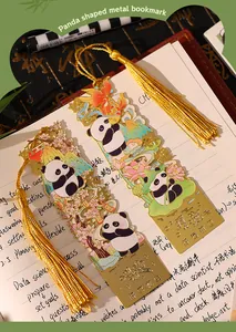 Detailed close-up of panda-shaped gold metal bookmarks with elegant silk tassels
