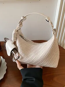 Modern cream woven hobo shoulder bag for women featuring a unique twisted handle design