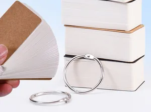 Close-up detail of blank loose-leaf flashcards with metal binder rings and kraft covers