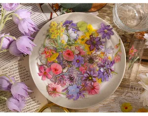 Close-up of vintage floral transparent stickers displayed on a decorative ceramic plate.