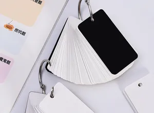 Close-up detail of blank black and white loose-leaf flashcards with metal rings