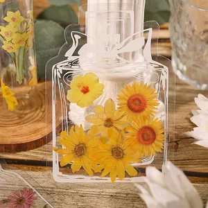 Aesthetic transparent bookmark with yellow dried flowers in a wish bottle shape