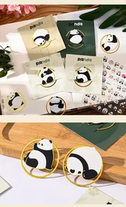 Detailed close-up of cute panda metal bookmarks in various poses on wooden tray