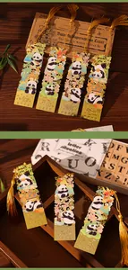 Detailed view of creative hollow metal panda bookmarks with elegant golden tassels in a wooden box