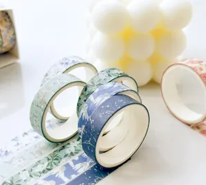 Multiple rolls of floral pattern washi tapes in aesthetic scene for journaling DIY craft